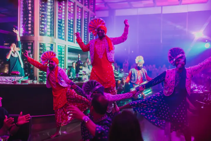 Diwali 2024: Dancers on the floor beside the club's bottle wall