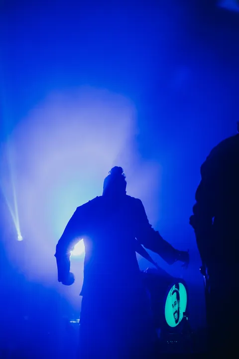 Diwali 2025: A performer silhouetted in blue haze