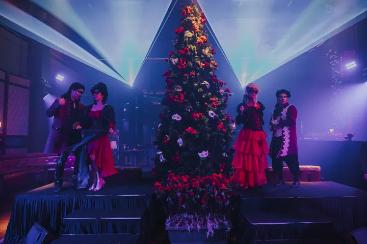 New Year's Eve 2024 · Masquerade: Masquerade stage: red-flower tree dressed with masks, costumed performers, beam lighting