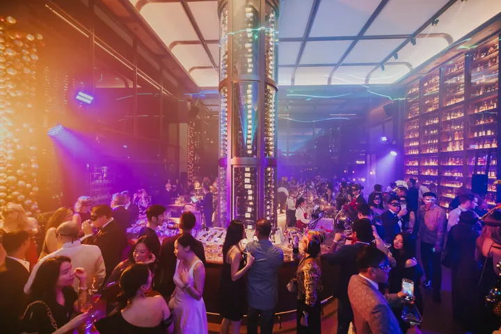 New Year's Eve 2024 · Masquerade: The main room lit in amber and blue around the club's bottle tower