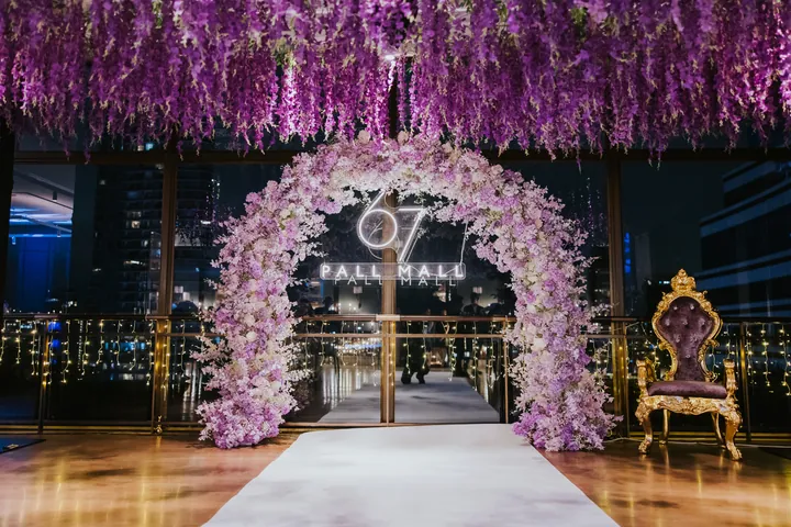 New Year's Eve 2025 · Wisteria: The lilac floral arch and neon sign on the terrace