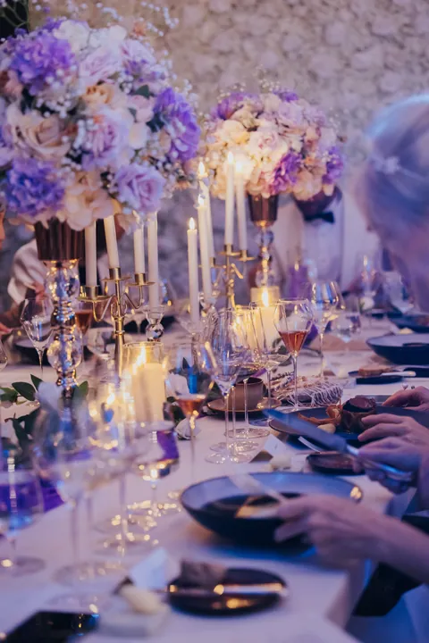 New Year's Eve 2025 · Wisteria: Lilac and white centrepieces with taper candles