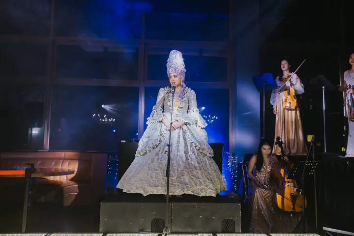 New Year's Eve 2025 · Wisteria: A performer on stage with string musicians