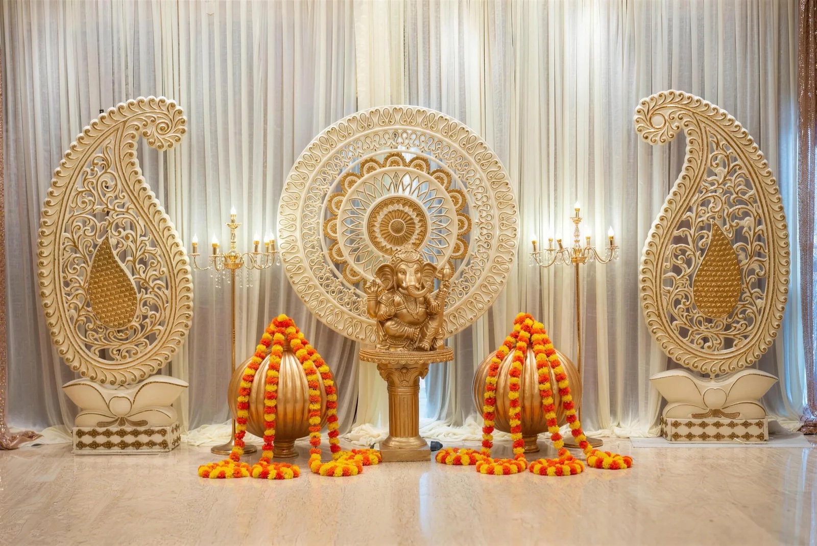 Our Ganesha stage with paisley panels and marigold garlands at PGP Hall