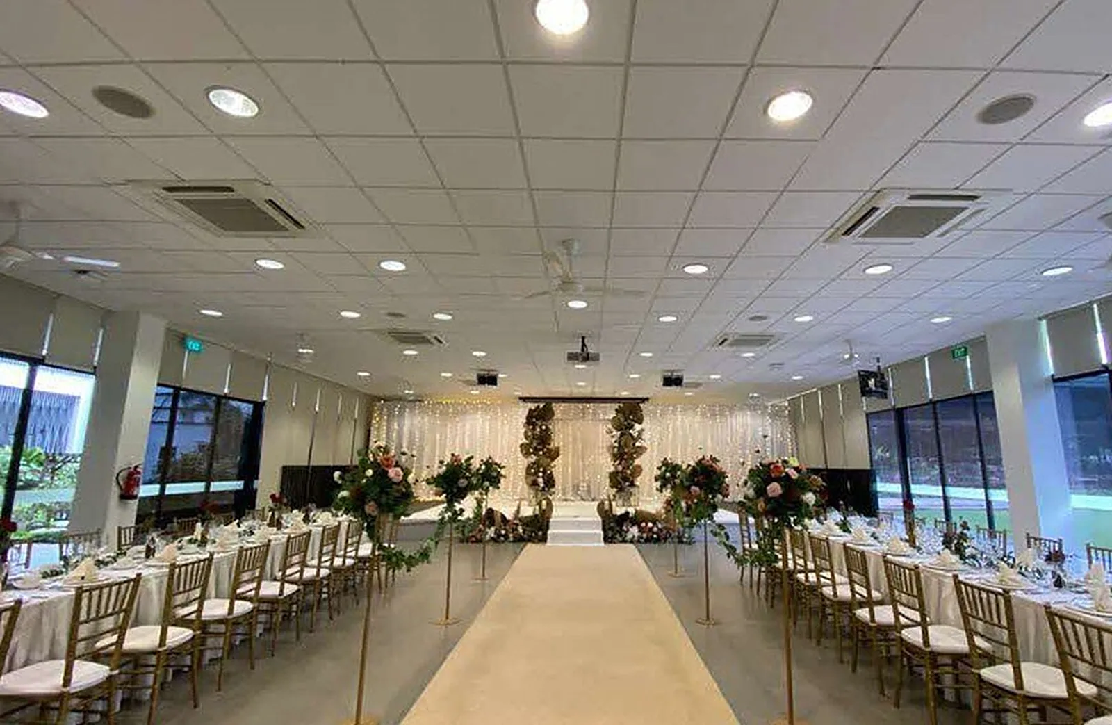 The air-conditioned Multi-Purpose Hall at HortPark set for a wedding, with an aisle to the stage