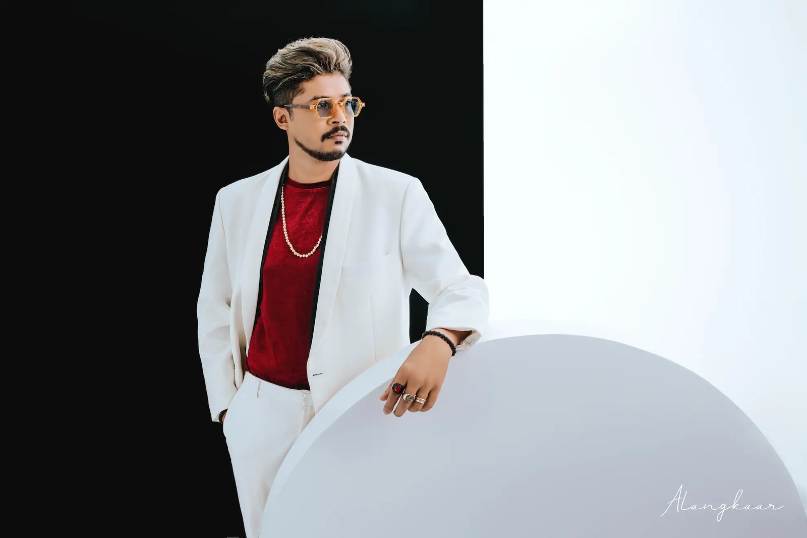 Man in a white suit photographed in the white studio at Alangkaar Studio